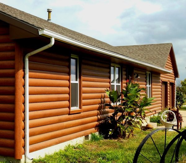 house done in rounded log siding look